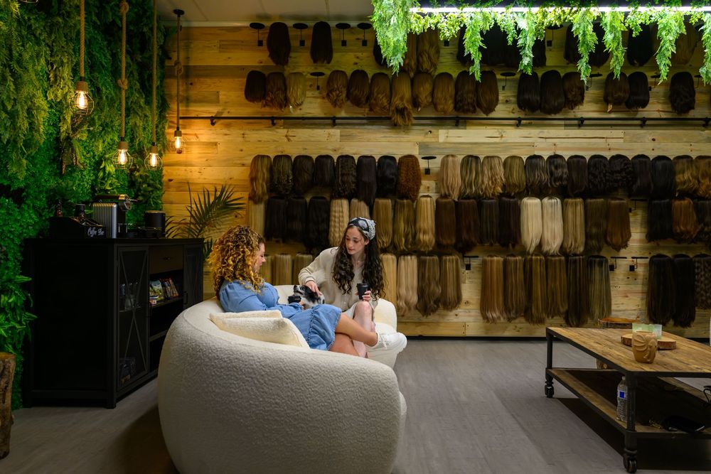 Wall of wigs in many hair types and colors at the Kalo Beauty Simplified showroom